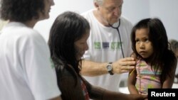 FILE - A Kayapo girl from Gorotire tribe with symptoms of Malaria fever receives medical attention on the sixth day of a medical expedition of the "Expedicionarios da Saude" (Brazilian Health Expeditions) in Kikretum community in Sao Felix, northern Brazi