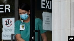 An individual wearing a face mask exits the Ouachita Parish Courthouse in Monroe, La., Aug. 5, 2021.