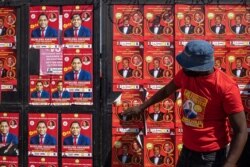 A man closes a door at the Matero district party headquarters for presidential candidate Hakainde Hichilema, of the Zambian opposition party United Party for National Development, in Lusaka, August 10, 2021.