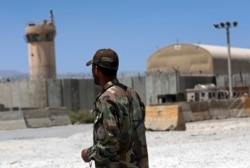 An Afghan Army soldier stand guard at the gate of Bagram Air Base in Afghanistan, Friday, June 25, 2021. (AP Photo/Rahmat Gul)