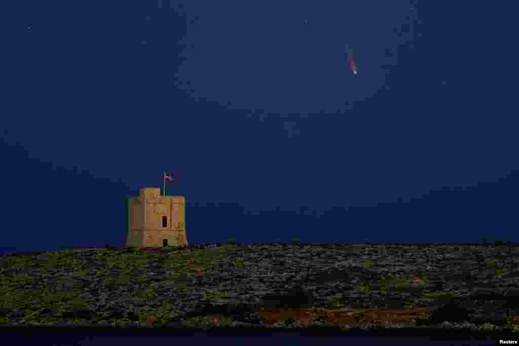 The Comet C/2020 or &quot;Neowise&quot; is seen in the sky behind St. Mark&#39;s Tower, a 17th century coastal fortification near the village of Bahar ic-Caghaq, Malta.