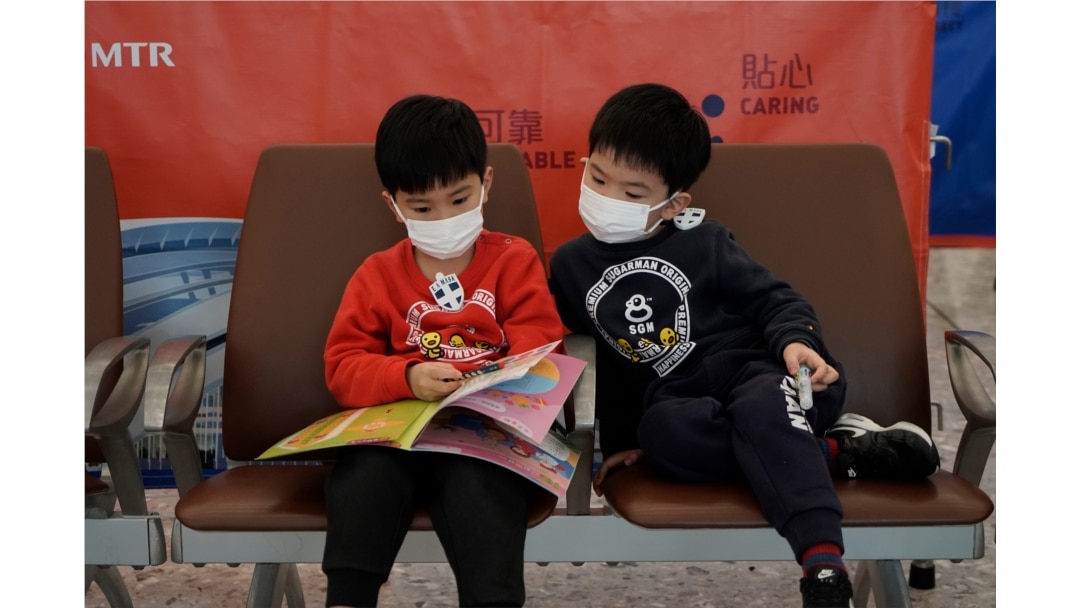 Passengers wear masks to prevent an outbreak of a new coronavirus in the high speed train station, in Hong Kong, Jan. 22, 2020.