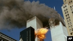 United Airlines Flight 175 collides into the south tower of the World Trade Center in New York as smoke billows from the north tower on September 11, 2001.
