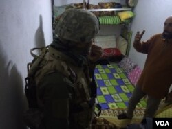 Aya's uncle Aymad shows soldiers a basement room that his family slept in for more than a week as mortars and gunfire rained down on nearby neighborhoods, finally reaching his as the Iraqi army recaptured it over the weekend in Mosul, Iraq, Jan. 23, 2017.
