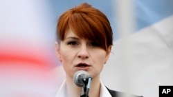 FILE - Maria Butina, leader of a pro-gun organization in Russia, speaks to a crowd during a rally in support of legalizing the possession of handguns in Moscow, Russia, April 21, 2013.