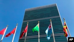 FILE - Flags fly outside the United Nations headquarters in New York.