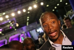 FILE - Democratic Alliance leader Mmusi Maimane gestures as he speaks to members of the media at the result center in Pretoria, South Africa, Aug. 4, 2016.