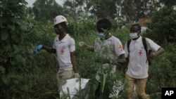 FILE - Red Cross volunteers carry the body of a civilian, who was killed in the Democratic Republic of Congo North Kivu province village of Mukondi, March 9, 2023.