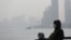 FILE - People wear protective masks during a polluted day in Shanghai, China, Jan. 19, 2016.