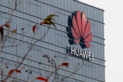 FILE - A logo of Huawei marks one of the company's buildings in Dongguan, in China's Guangdong province, March 6, 2019.