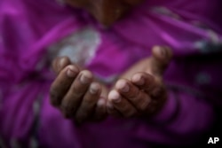 A Muslim woman prays at the shrine of Sufi saint Khwaja Moinuddin Chishti during the Urs festival in Ajmer, in the western Indian state of Rajasthan, India, Friday, April 24, 2015.