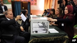 FILE - Algerian President Abdelaziz Bouteflika casts his ballot to vote in Algiers,May 4, 2017.