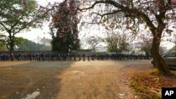 FILE: Schoolchildren queue outside their school in Harare, Zimbabwe. 