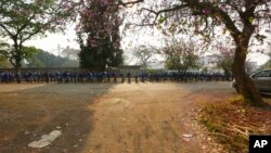 FILE: Schoolchildren queue outside their school in Zimbabwe, Monday, Sept, 28, 2020. 