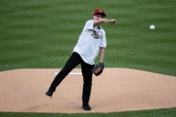 Dr. Anthony Fauci throws out a ceremonial first pitch before MLB Opening Day between the Washington Nationals and the New York Yankees at Nationals Park, July 23, 2020, in Washington.