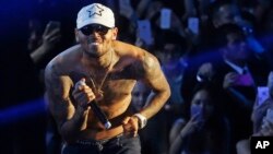 FILE - Grammy award-winning singer Chris Brown performs at a club in Macau.
