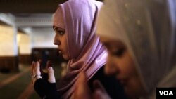 Young women pray in the Heart of Chechnya mosque during Friday Prayer.