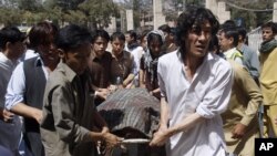 Pakistani Shiite Muslims carry the body of a person killed by gunmen at a local hospital in Quetta, Pakistan, Sept. 1, 2012. 