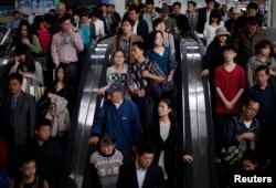 People enter a subway station in People's Square, Shanghai April 28, 2011.