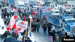 Trucks sit parked near Parliament buildings as truckers and their supporters take part in a convoy to protest COVID-19 vaccine mandates, in Ottawa, Canada, Jan. 29, 2022.