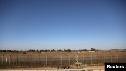 FILE - Israeli soldiers patrol the cease-fire line between Israel and Syria, as seen from the Israeli-occupied Golan Heights, July 26, 2018.