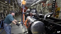 Thomas Warren installs a fuel cell on a Freightliner truck at a plant in Cleveland, NC, January 12, 2012.