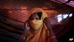 FILE - S, 22, mother of one, who says she was raped by members of Myanmar's armed forces in late August, is photographed in her tent in Gundum refugee camp in Bangladesh, Nov. 23, 2017. 