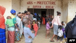 FILE - Refugees from the Central African Republic wait in line to be registered in Garoua-Boulai, Cameroon, Jan. 8, 2021. Cameroon has had an influx of street children in its largest cities, with some of them Central African Republic refugees. 