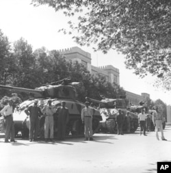 Iranian army troops and tanks stand in front of Central Police headquarters after the attempted coup d'etat against Iranian Premier Mohammad Mossadeq in Tehran, Iran, Aug. 16, 1953.
