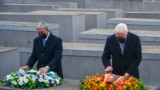 German President Frank-Walter Steinmeier, right, and the Speaker of Israel's Parliament Mickey Levy arrange wreaths on one of the concrete slabs of Berlin's Holocaust Memorial, Jan. 27, 2022, marking International Holocaust Remembrance Day.