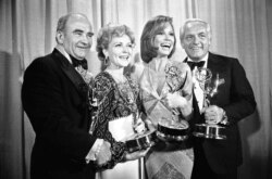 FILE - Cast members of the "Mary Tyler Moore Show" pose with their Emmys backstage in Los Angeles, May 18, 1976. From left are Ed Asner, Betty White, Mary Tyler Moore and Ted Knight.