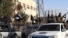 FILE - Members of the Islamic State militant group parade in the northern rebel-held Syrian city of Raqqa. Carter said if the U.S. finds additional groups willing to fight IS in Syria, he and President Barack Obama are prepared to deploy additional U.S. forces there.