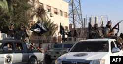 An image made available by Jihadist media outlet Welayat Raqa on June 30, 2014, allegedly shows a member of the IS (Islamic state) militant group parading in a street in the northern rebel-held Syrian city of Raqqa.