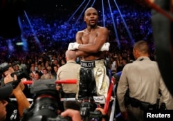 Floyd Mayweather, Jr. of the U.S. stands up on the ropes in his corner after defeating Manny Pacquiao of the Philippines in their welterweight WBO, WBC and WBA (Super) title fight in Las Vegas, Nevada, May 2, 2015.