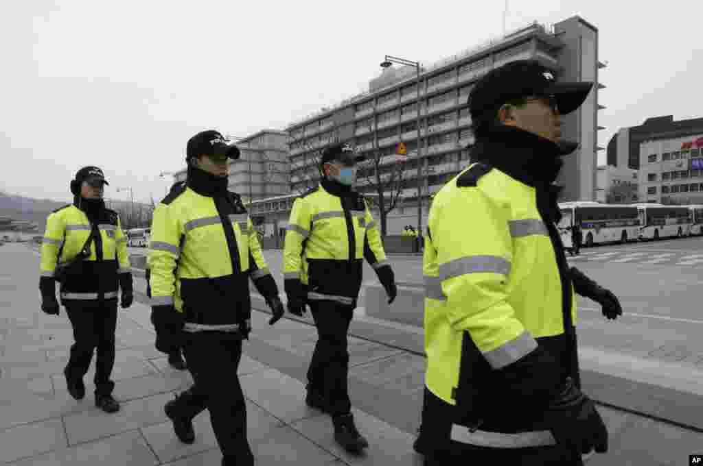 South Korean police officers patrol near the U.S. Embassy in Seoul, South Korea, March 5, 2015.