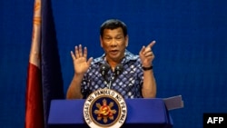 FILE - Philippine President Rodrigo Duterte gestures during the Partido Demokratiko Pilipino-LakasBayan (PDP-LABAN) meeting in Manila on May 11, 2019, ahead of Monday's the midterm elections.