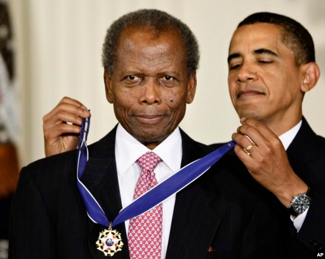 FILE - President Barack Obama presents Sidney Poitier with the 2009 Presidential Medal of Freedom during a ceremony in the East Room of the White House in Washington on August 12, 2009.