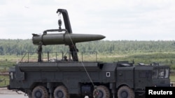 FILE - Russian servicemen equip an Iskander tactical missile system at the Army-2015 international military-technical forum in Kubinka, outside Moscow, Russia, June 17, 2015. 