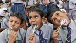 Children in New Delhi in a 2007 attempt to break a world record for the most people brushing their teeth together in multiple venues