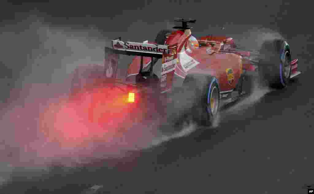 Ferrari driver Fernando Alonso of Spain controls his car on turn two during the qualifying session at Albert Park ahead of the Australian Formula One Grand Prix in Melbourne.