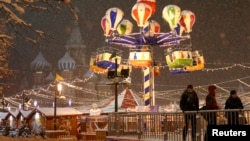 FILE - People gather near a New Year fair in Red Square, Moscow, Russia.