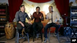 Members of the Colombian salsa band Sonora Carruseles, Leonardo Sierra, left, Daniel Marmolejo, center, and Jans Certuche, right, sing one of their hits during an interview in Doral, Florida, Aug. 17, 2015.