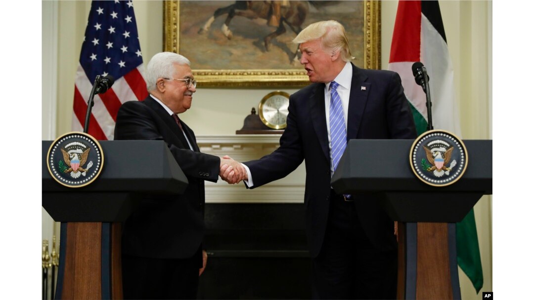President Donald Trump shakes hands with Palestinian leader Mahmoud Abbas after their statements in the Roosevelt Room of the White House in Washington, May 3, 2017.