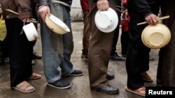 Chinese migrant workers queue for lunch near a construction site in Beijing. (FILE)