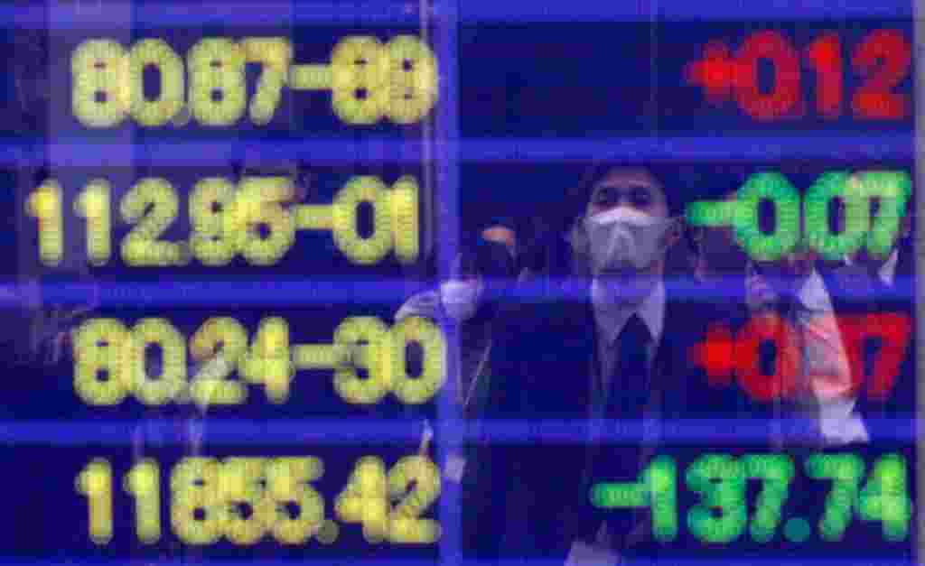 A screen displays stock prices in Tokyo March 16. The Nikkei index ended the morning up 4.37 pct after closing down 10.6 percent on Tuesday and 6.2 percent the day before. The fall wiped some $620 billion off the market. (Reuters/Issei Kato)