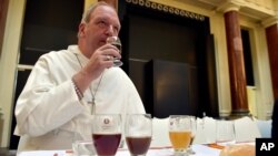 FILE - Abbot Erik de Sutter of Belgium's Grimbergen Abbey tastes a beer at the start of the Brussels Beer Challenge in Brussels, Belgium, Nov. 4, 2016.