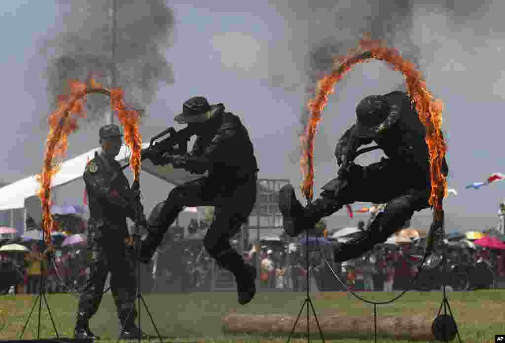 Personel Tentara Pembebasan Rakyat (PLA) People&#39;s Liberation Army (PLA) melakukan aksi dengan lingkaran api dalam pembukaan Pangkalan Angkatan Laut Pulau Stonecutter di Hong Kong, yang menandai peringatan 18 tahun diserahkannya Hong Kong ke China (1/7). (AP/Kin Cheung)