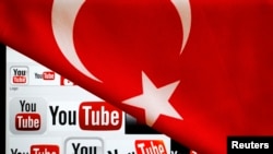 YouTube logos displayed on a laptop screen partially covered with Turkey's national flag in this photo illustration taken in Ankara, March 27, 2014. 