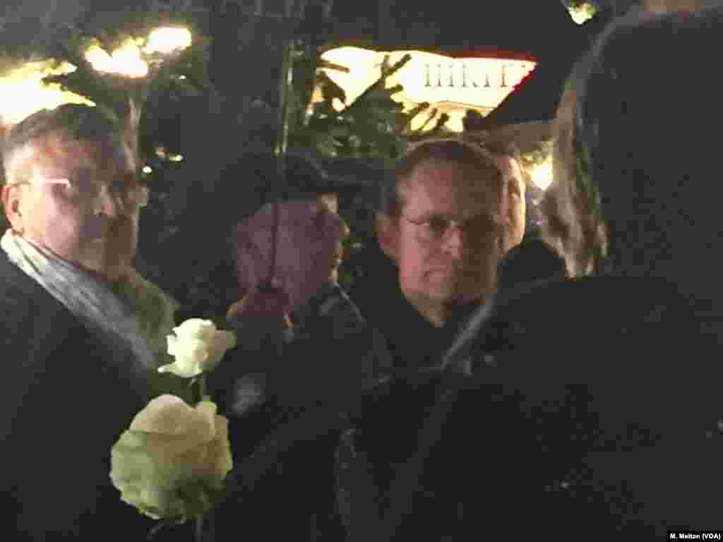 Berlin Mayor Michael Muller, right, assured Berliners that while &quot;there cannot be absolute security&quot; at the public market, the city has taken all measures possible to guard against any repeat of last year&#39;s attack. Muller was one of a number of officials who placed a white rose at a memorial to the victims of the attack.