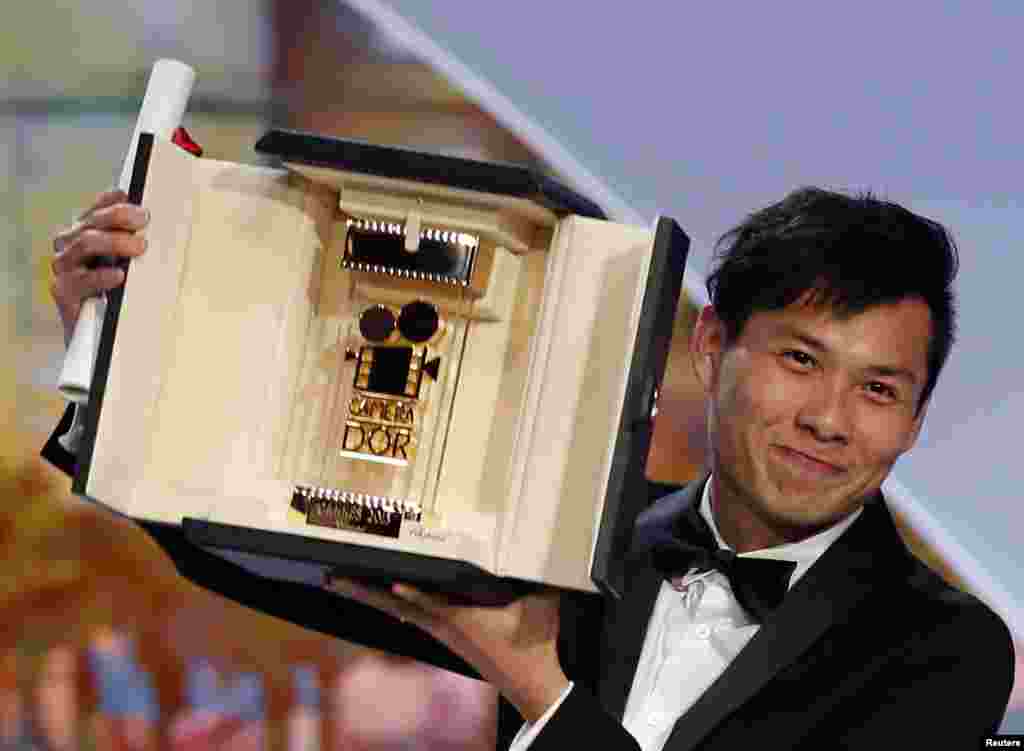 Director Anthony Chen, Camera d'Or award winner for the film "Ilo Ilo", poses on stage during the closing ceremony of the 66th Cannes Film Festival, May 26, 2013.